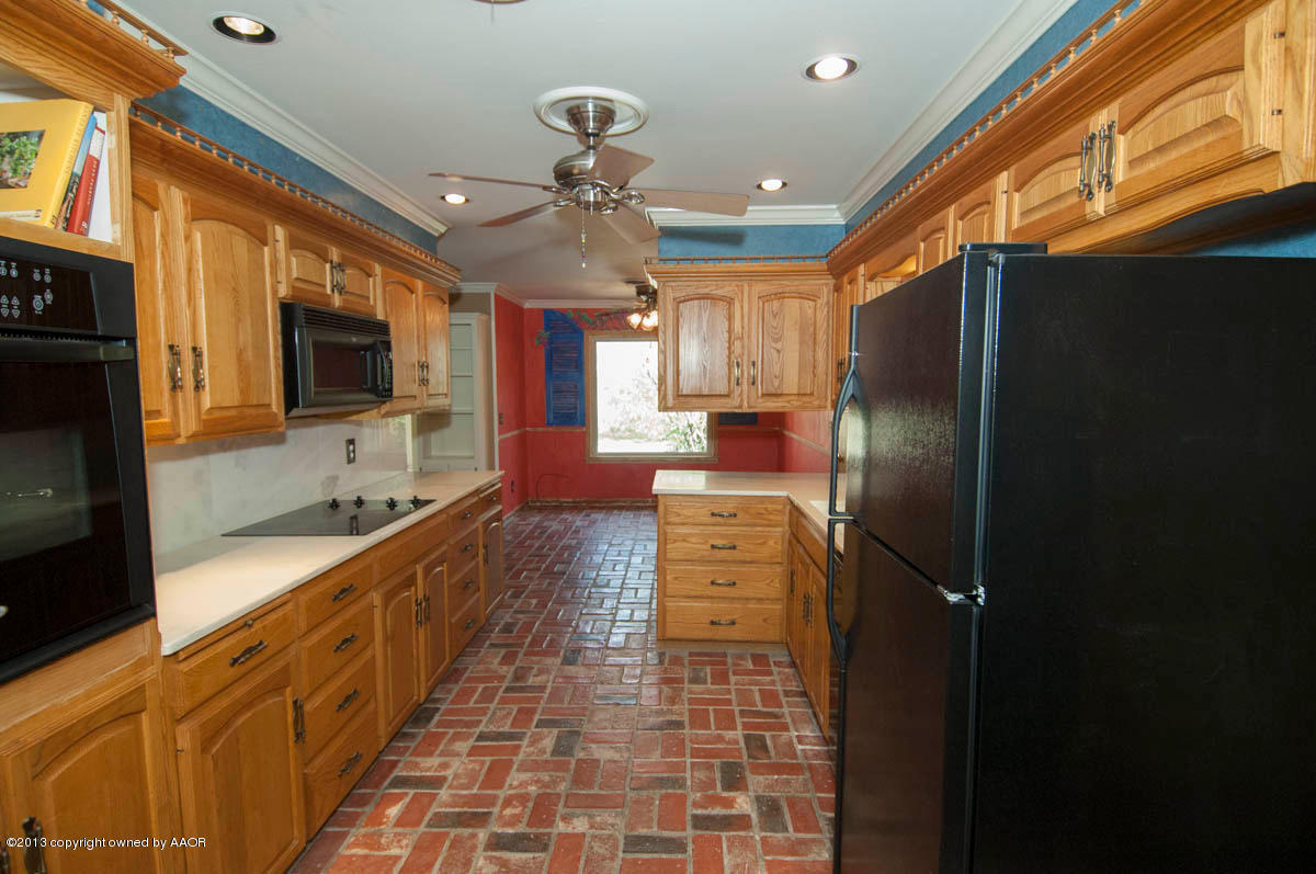 6206 Calumet Road Amarillo, TX 79106 - Photo 11 of 47 a large kitchen with stainless steel appliances a refrigerator and a sink