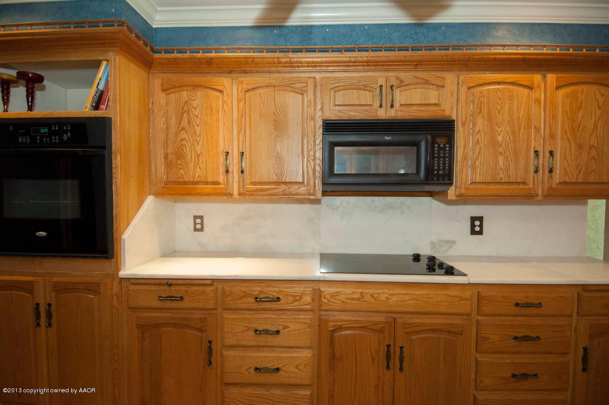 6206 Calumet Road Amarillo, TX 79106 - Photo 13 of 47 a kitchen with granite countertop white cabinets stainless steel appliances and sink