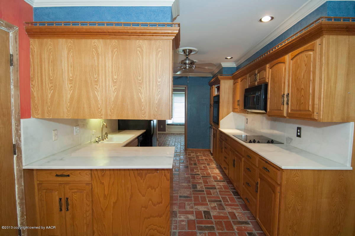 6206 Calumet Road Amarillo, TX 79106 - Photo 14 of 47 a kitchen with a sink and a refrigerator