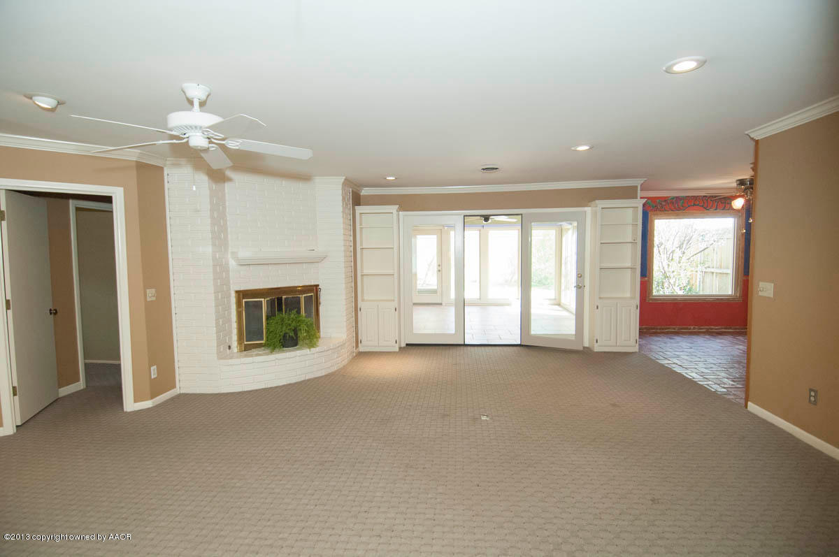 6206 Calumet Road Amarillo, TX 79106 - Photo 7 of 47 an empty room with windows and fireplace