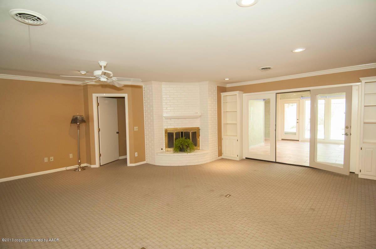 6206 Calumet Road Amarillo, TX 79106 - Photo 8 of 47 an empty room with windows and chandelier fan
