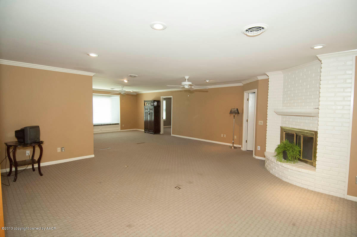 6206 Calumet Road Amarillo, TX 79106 - Photo 9 of 47 a view of an empty room with a fireplace and a window