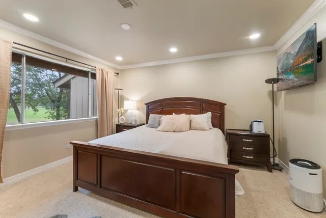 a bedroom with a bed and a tv