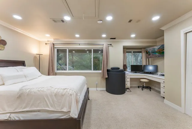 a room with a bed and a large window