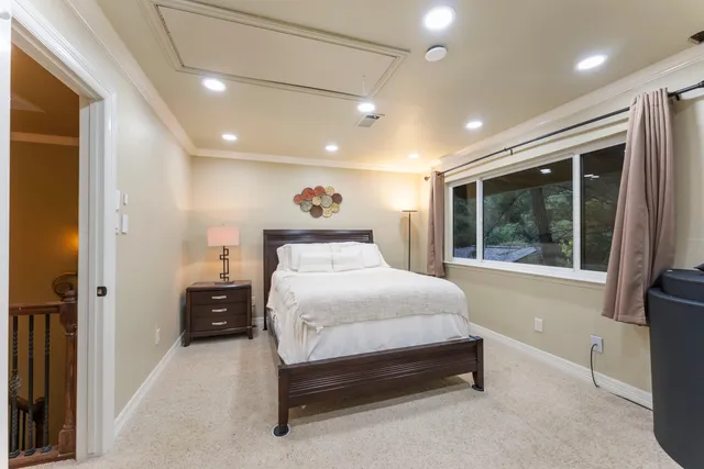 a bedroom with a bed and a large window