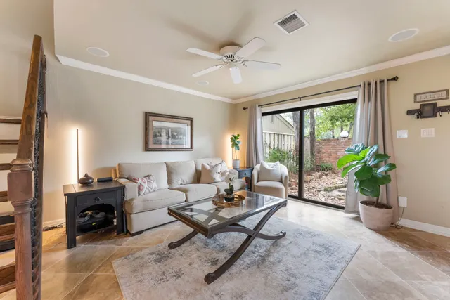 a living room with furniture a chandelier and a window