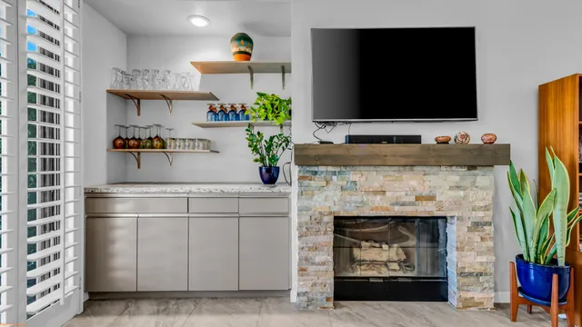 a living room with furniture a flat screen tv and a fireplace