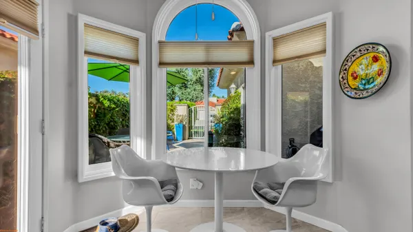 a dining room with furniture and a window