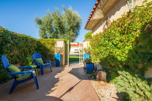 a view of a chairs and table in backyard