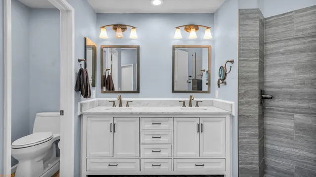 a bathroom with a double vanity sink and a mirror