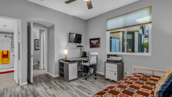 a view of a workspace with furniture and a window