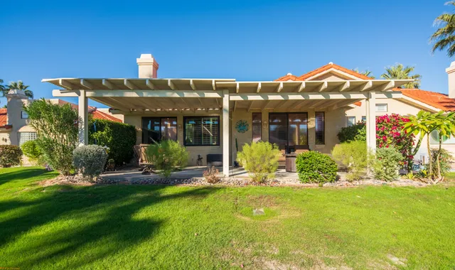 a front view of house with outdoor seating and yard