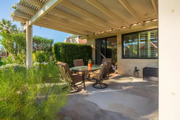 a view of a house with backyard sitting area and garden