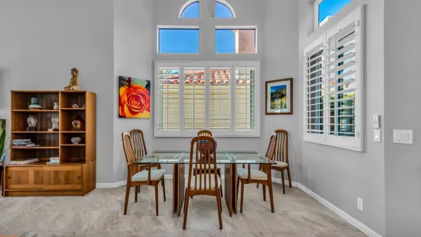 a dining room with furniture and window