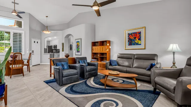 a living room with furniture ceiling fan and a rug