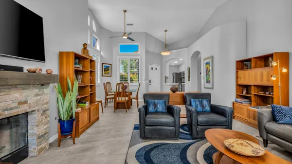 a living room with furniture a flat screen tv and a fireplace