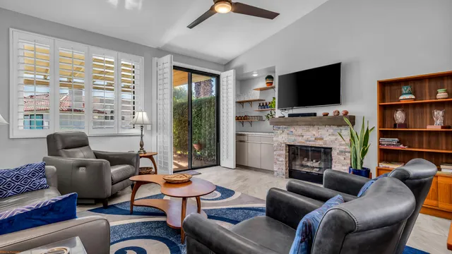 a living room with furniture a fireplace and a flat screen tv
