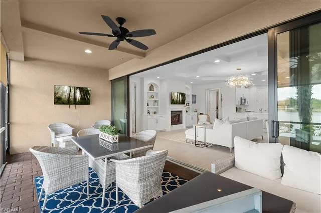 a living room with furniture and a view of kitchen