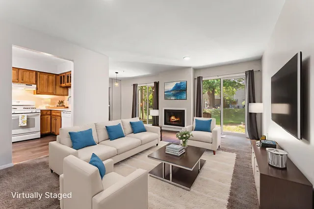 a living room with furniture flat screen tv and large window