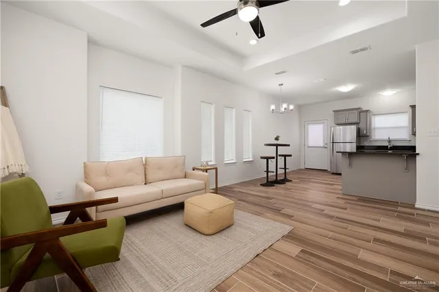 a living room with furniture and kitchen view