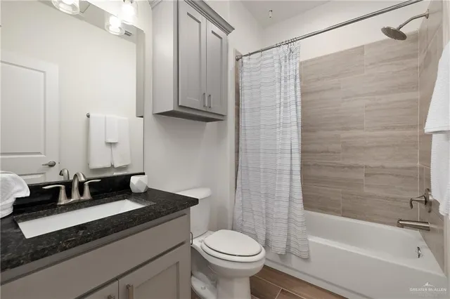 a bedroom with a bed and a ceiling fan