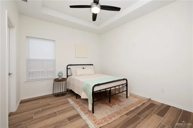 a bathroom with a granite countertop sink a toilet and a mirror
