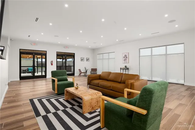 a kitchen with stainless steel appliances granite countertop a refrigerator a stove a sink and a microwave