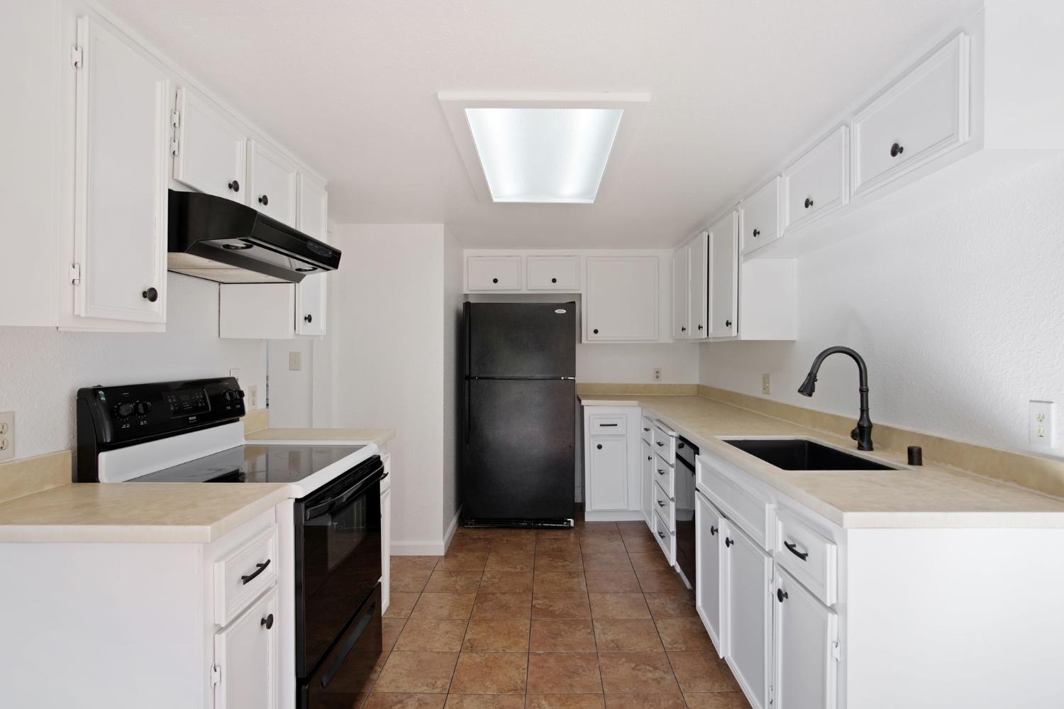 3701 Colonial Drive, Unit 156 Modesto, CA 95356 - Photo 16 of 32 a kitchen with stainless steel appliances granite countertop a sink stove and refrigerator