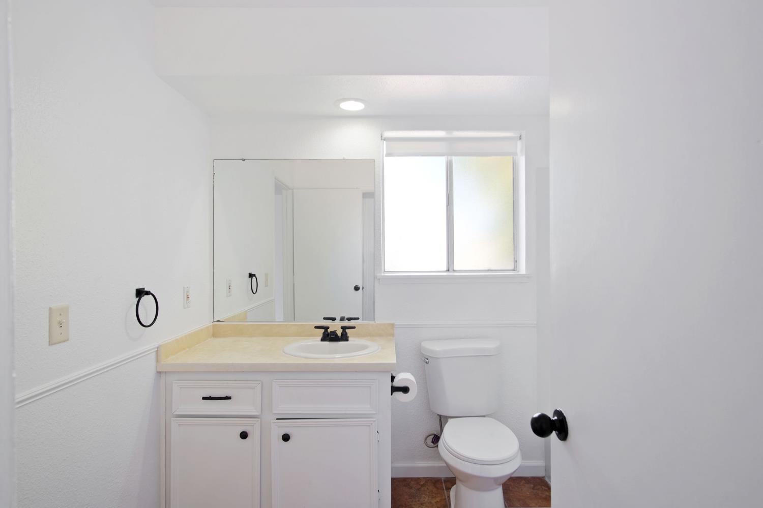 3701 Colonial Drive, Unit 156 Modesto, CA 95356 - Photo 20 of 32 a bathroom with a sink a toilet and a mirror