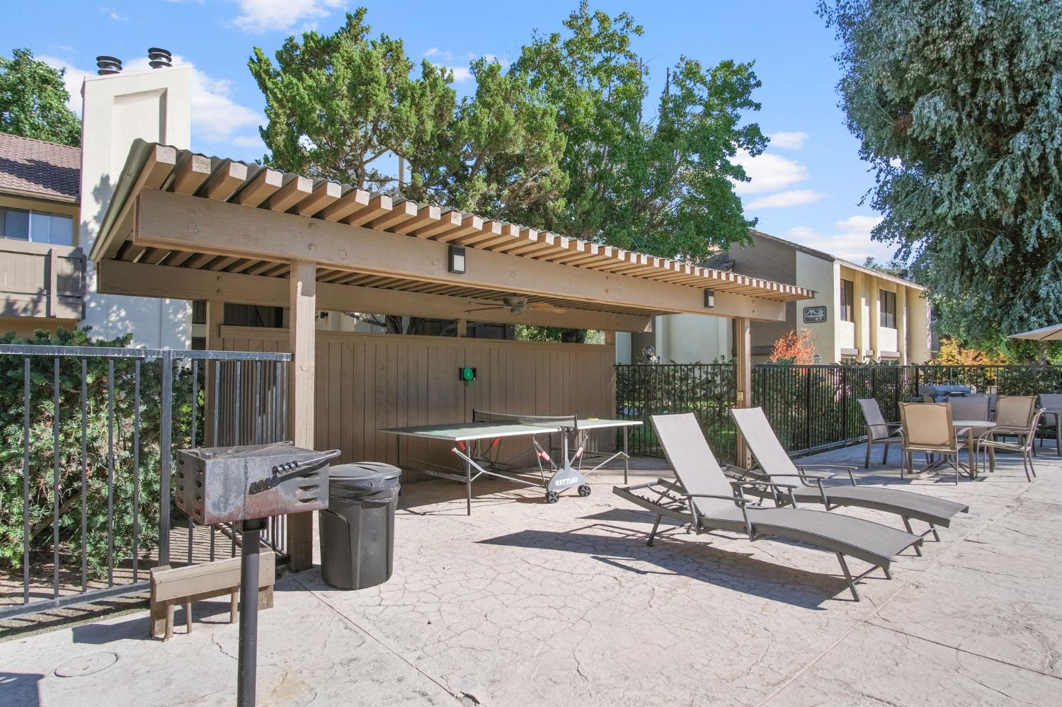 3701 Colonial Drive, Unit 156 Modesto, CA 95356 - Photo 4 of 32 a view of a patio with table and chairs and potted plants