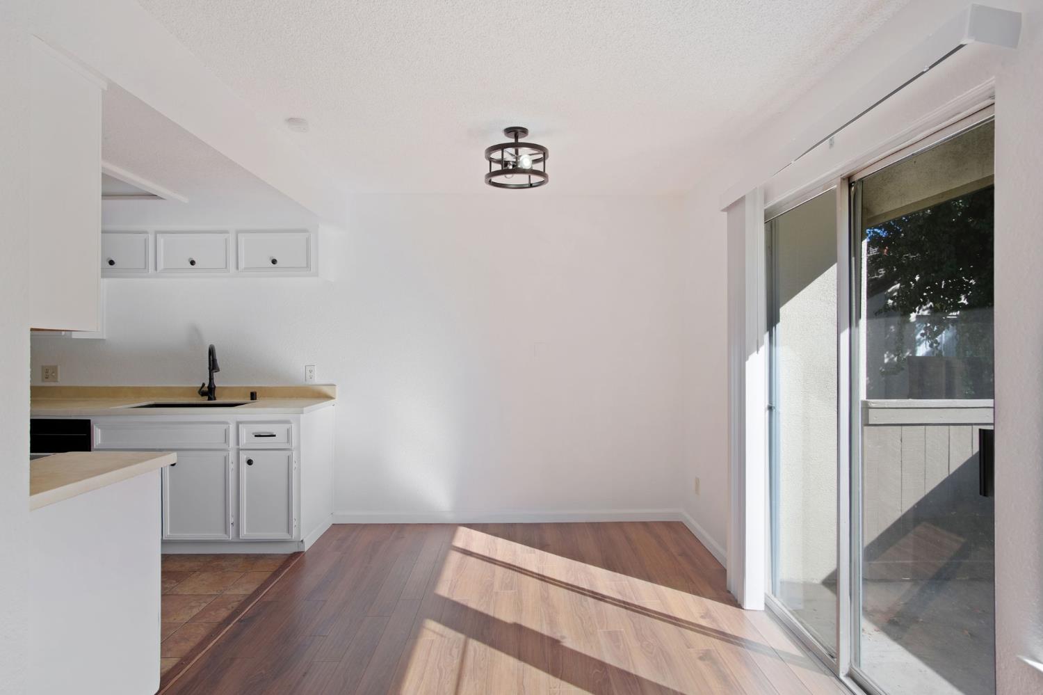 3701 Colonial Drive, Unit 156 Modesto, CA 95356 - Photo 7 of 32 a kitchen with a sink cabinets and wooden floor
