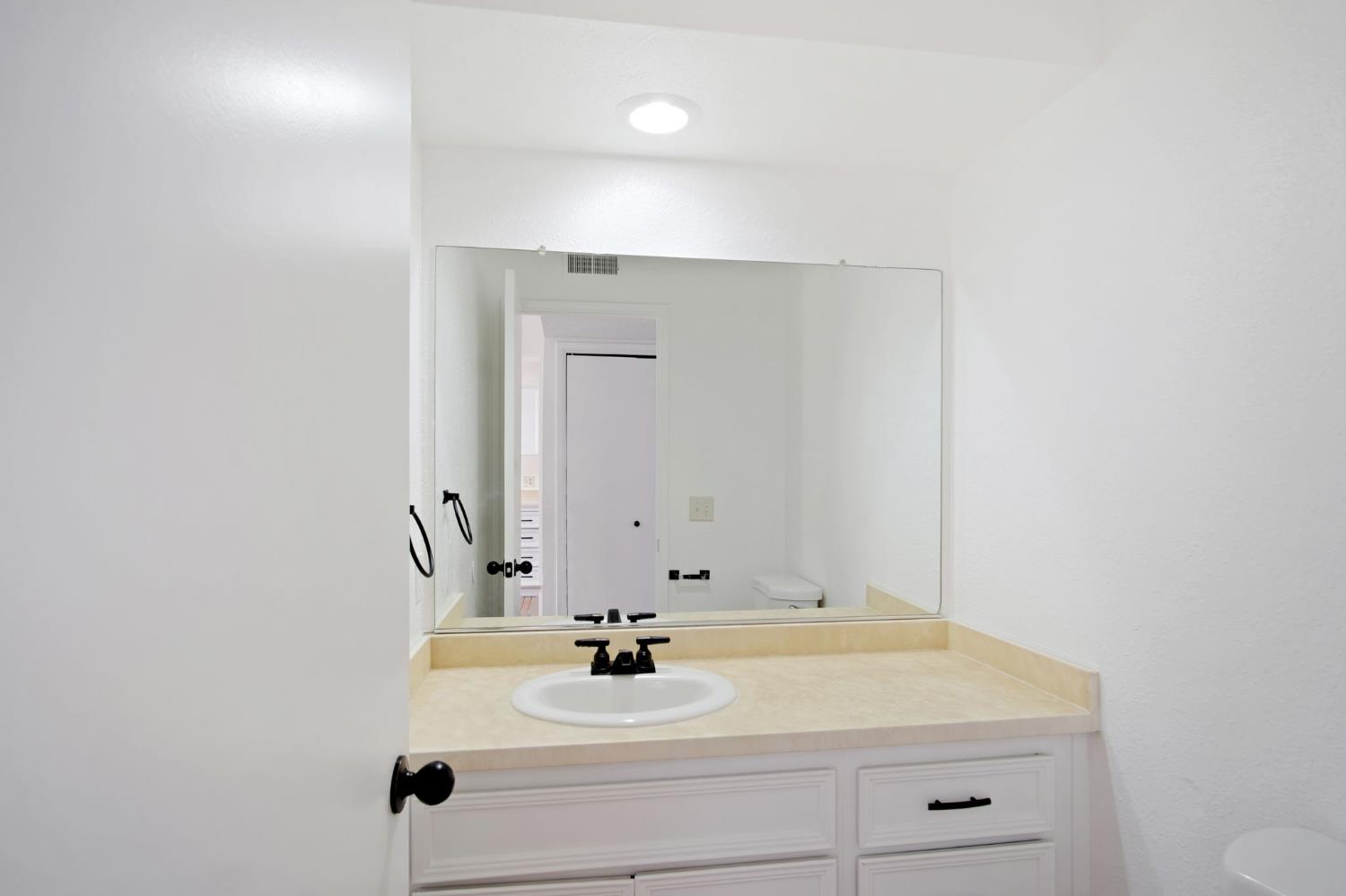 3701 Colonial Drive, Unit 156 Modesto, CA 95356 - Photo 9 of 32 a bathroom with a sink and a mirror