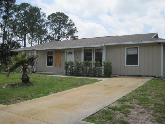 120 Southwest Ware Palm Bay, FL 32908 - Photo 1 of 11 a front view of house with yard and green space