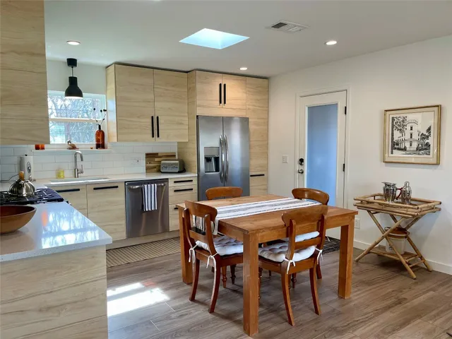a living room with stainless steel appliances kitchen island granite countertop a couch and a view of living room