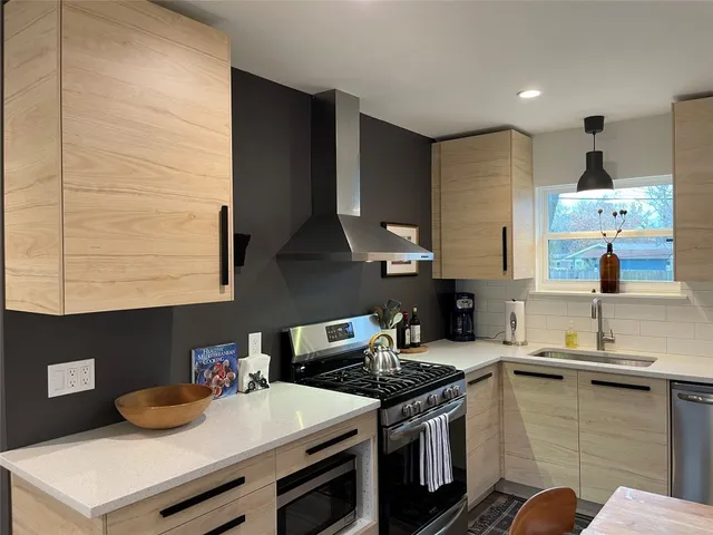 a living room with furniture kitchen view and a table