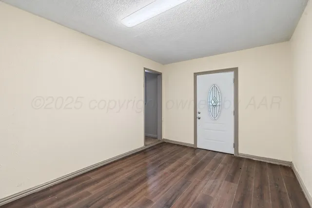 an empty room with wooden floor