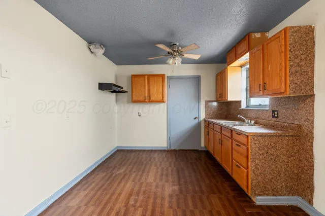 a kitchen with wooden floors and a sink