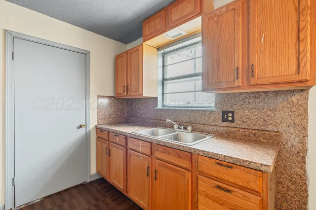a kitchen with a sink and cabinets