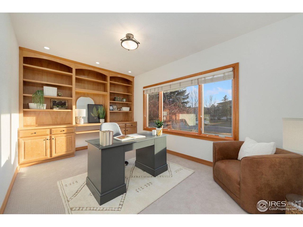 7930 Eagle Ranch Road Fort Collins, CO 80528 - Photo 13 of 40 a living room with a large window and a table