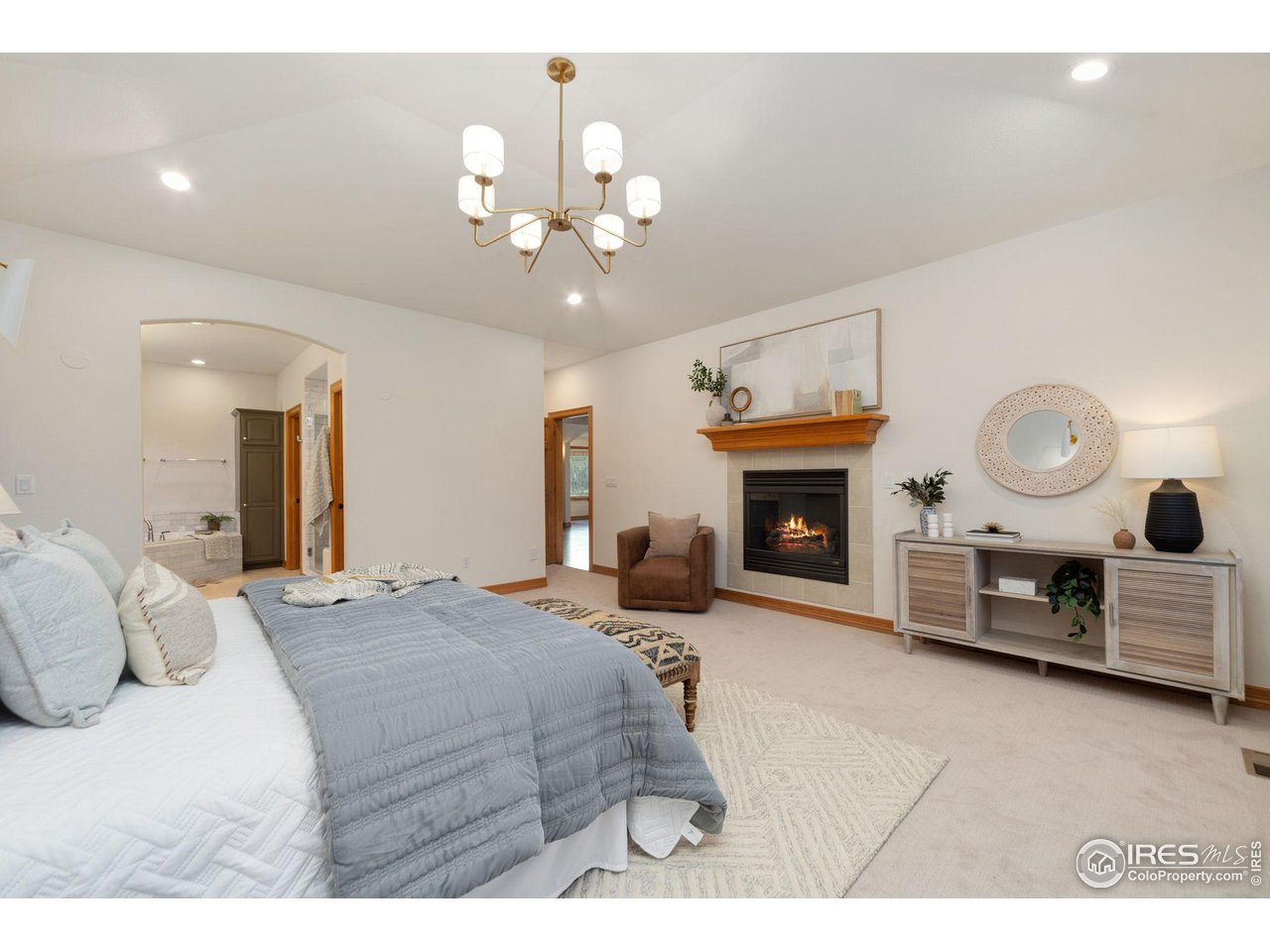 7930 Eagle Ranch Road Fort Collins, CO 80528 - Photo 15 of 40 a bedroom with a bed fireplace desk and chair