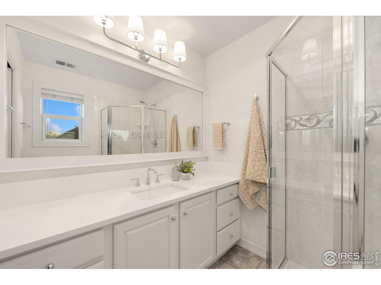 7930 Eagle Ranch Road Fort Collins, CO 80528 - Photo 21 of 40 a bathroom with a sink a mirror a vanity and shower