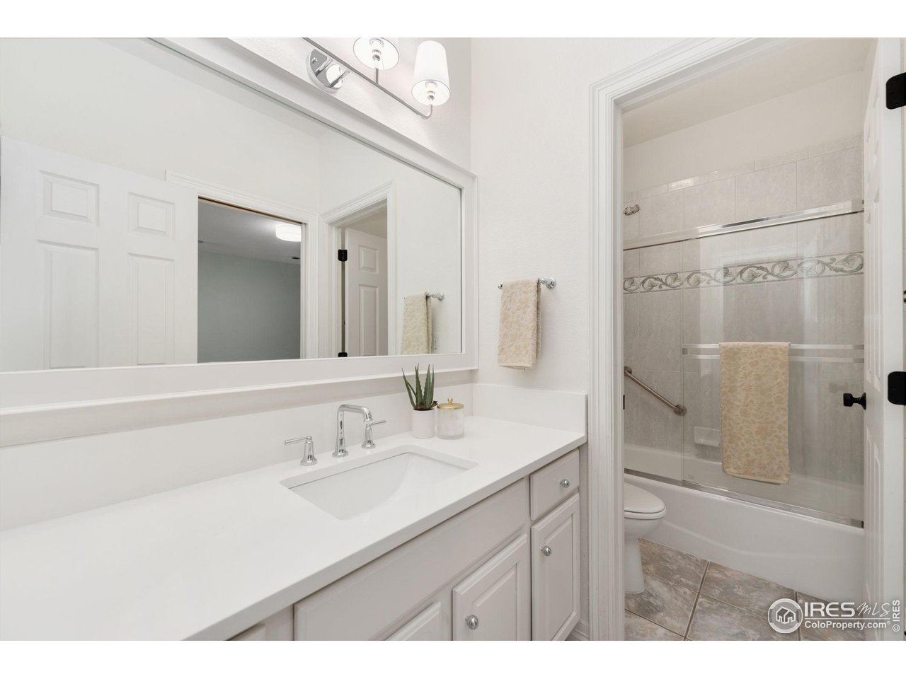 7930 Eagle Ranch Road Fort Collins, CO 80528 - Photo 31 of 40 a bathroom with a sink double vanity granite tub shower and a mirror