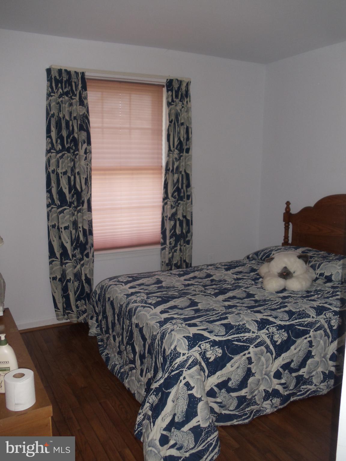 2186 Golf Course Drive Reston, VA 20191 - Photo 17 of 30 a bed sitting in a bedroom next to a window