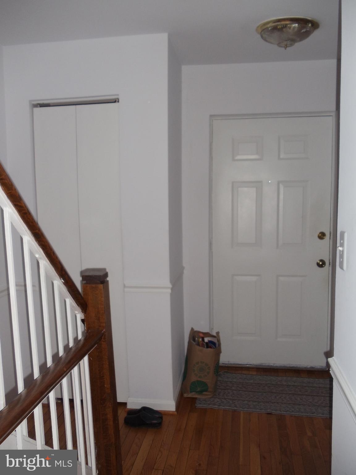 2186 Golf Course Drive Reston, VA 20191 - Photo 6 of 30 a view of an empty room with wooden floor and stairs