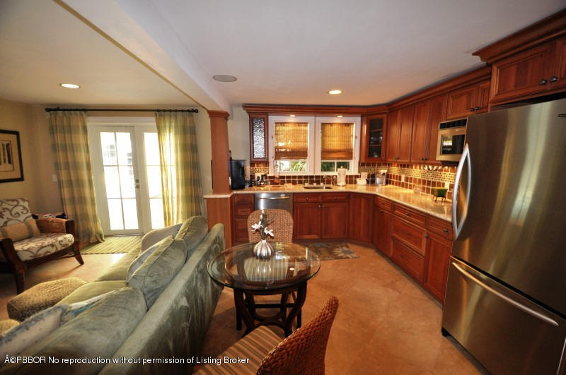 272 Cordova Road West Palm Beach, FL 33401 - Photo 14 of 15 a kitchen with stainless steel appliances granite countertop a stove a refrigerator a sink a dining table and chairs with wooden floor