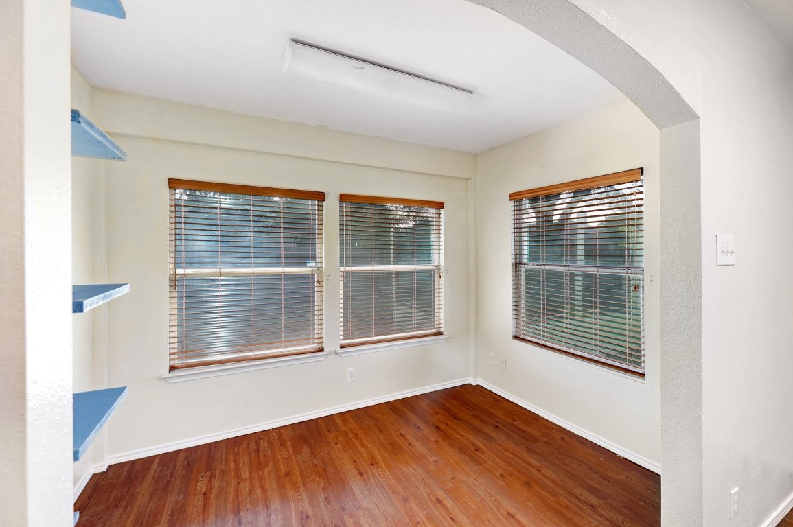 301 Nicole Way Bastrop, TX 78602 - Photo 11 of 23 a view of an empty room with wooden floor and windows
