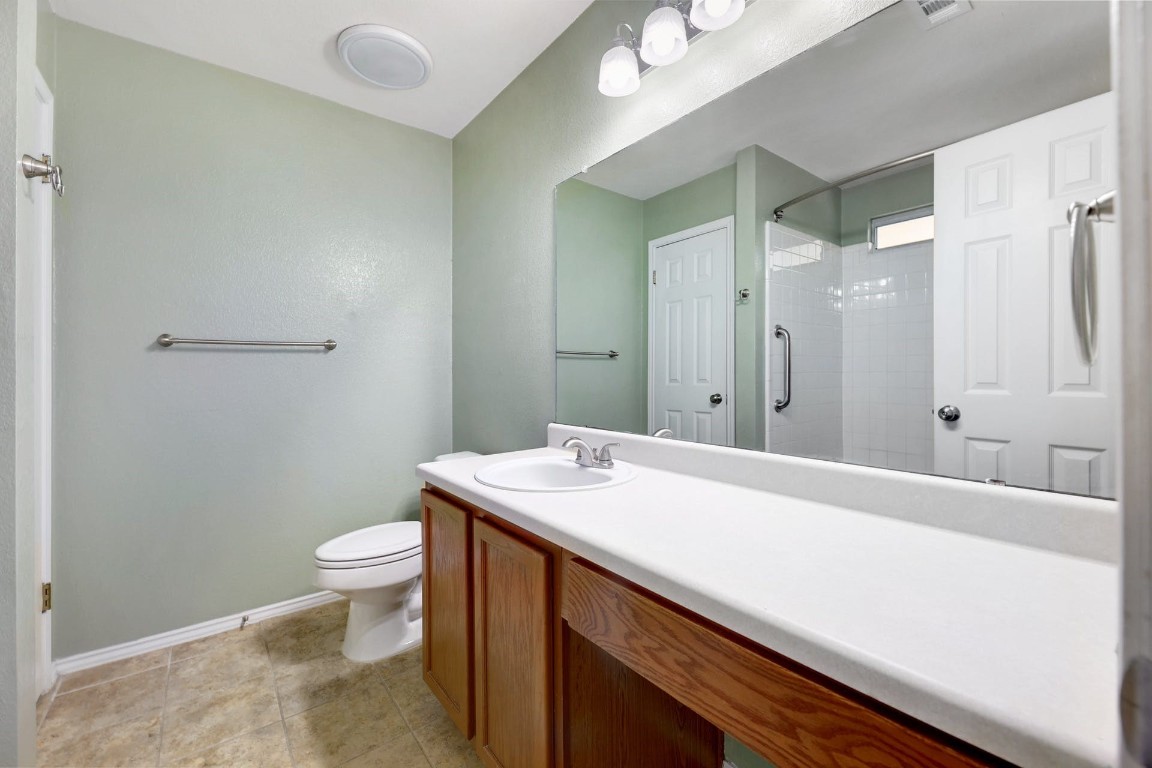 301 Nicole Way Bastrop, TX 78602 - Photo 13 of 23 a bathroom with a sink a toilet and shower