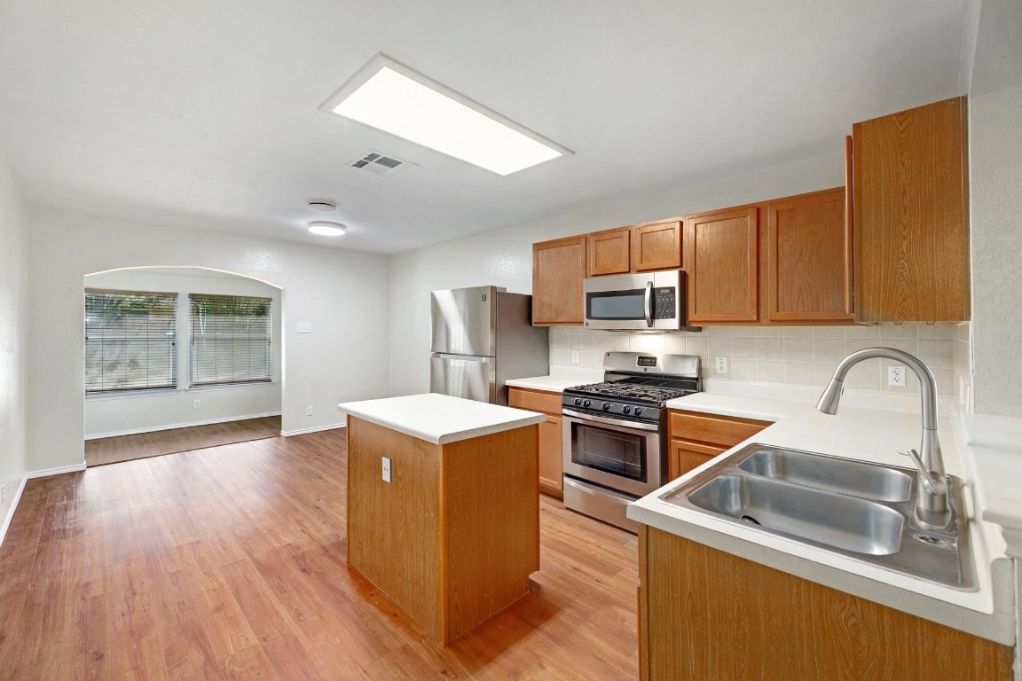 301 Nicole Way Bastrop, TX 78602 - Photo 7 of 23 a kitchen with stainless steel appliances granite countertop a sink stove and refrigerator