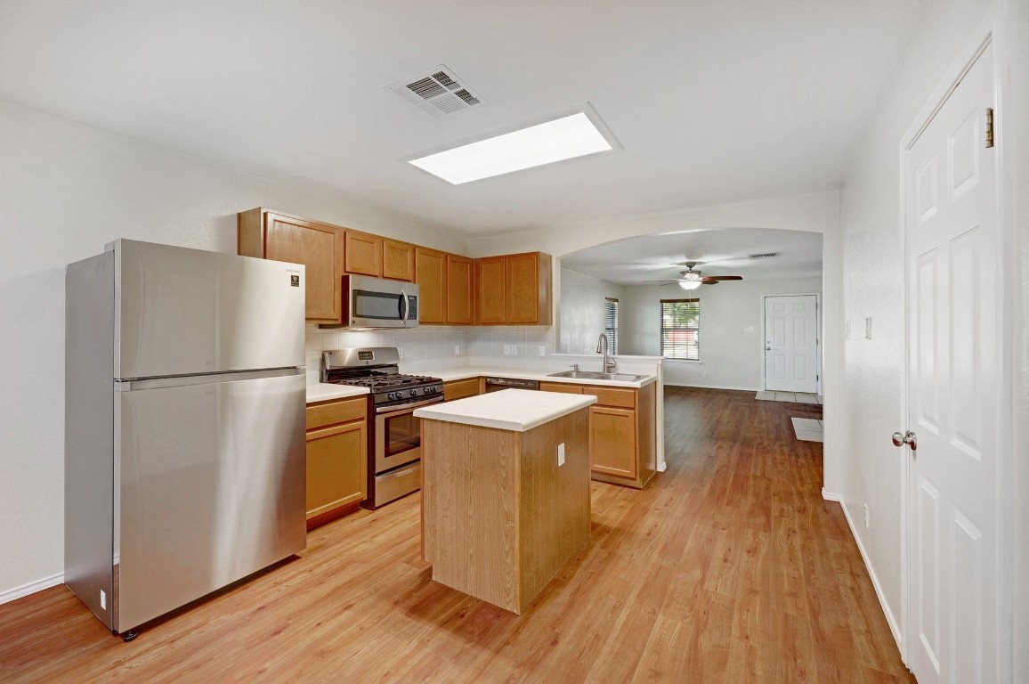 301 Nicole Way Bastrop, TX 78602 - Photo 8 of 23 a kitchen with a refrigerator a stove top oven and wooden floor
