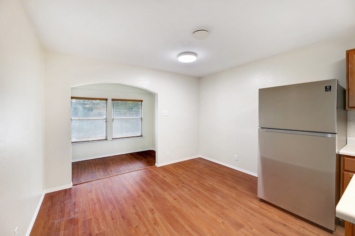 301 Nicole Way Bastrop, TX 78602 - Photo 10 of 23 a view of an empty room with a window and wooden floor